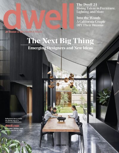 A family gathering around a dining table in a modern architectural space with high ceilings and expansive windows.